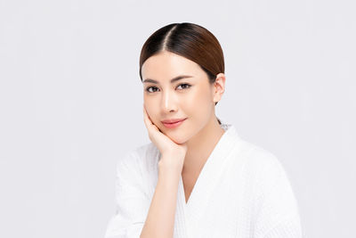 Portrait of a smiling young woman over white background