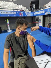 Man taking vaccine on arm