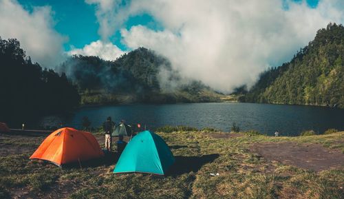 Scenic view of lake and mountains against sky