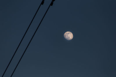 Low angle view of moon against clear sky at night