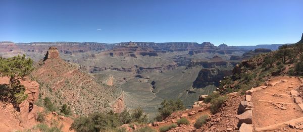 Panoramic view of rocky mountains against clear sky