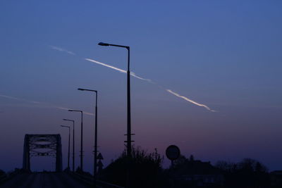 Low angle view of silhouette street light against sky at night