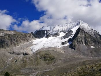 Scenic view of mountains against cloudy sky