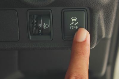 Cropped hand pressing button in car