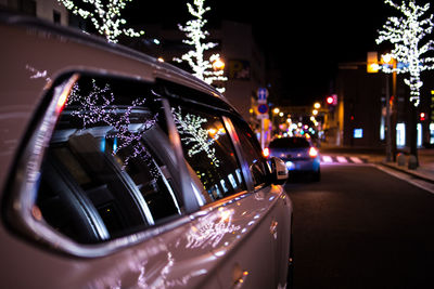Close-up of illuminated car on city at night