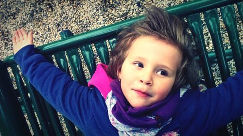 High angle view of girl on bench at playground