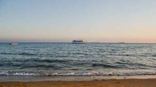 Scenic view of sea against clear sky during sunset