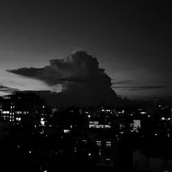 High angle view of illuminated buildings against sky at night