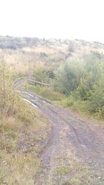 Road by landscape against clear sky