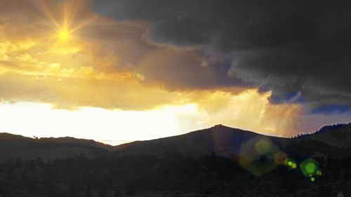 Scenic view of silhouette mountains against sky at sunset