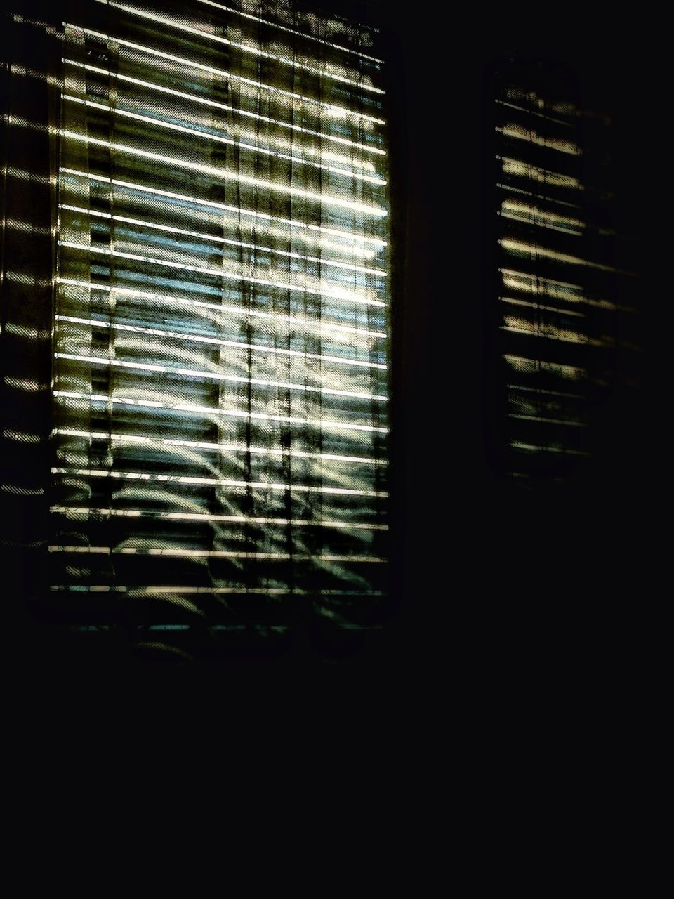 indoors, window, dark, glass - material, transparent, blinds, architecture, home interior, built structure, no people, curtain, close-up, illuminated, house, reflection, pattern, sunlight, darkroom, glass, day
