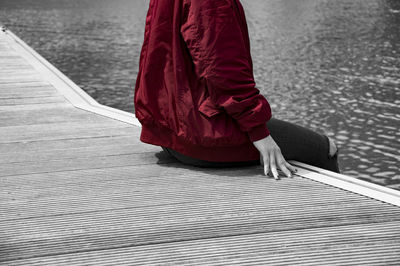 Low section of woman standing on road