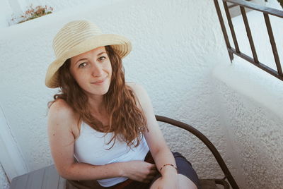 Portrait of a smiling young woman wearing hat