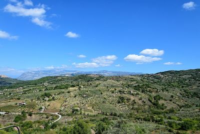 Scenic view of landscape against blue sky