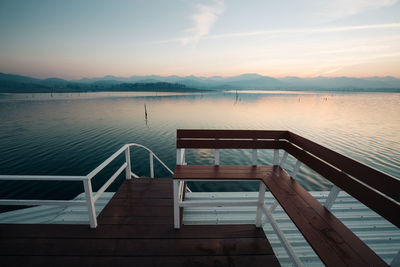 Wooden bench by lake