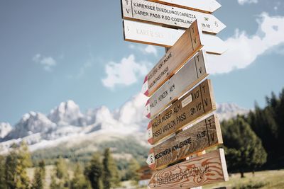 Low angle view of information sign against sky