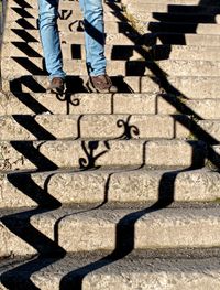 Low section of man standing on tiled floor