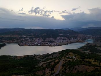 High angle view of sea and mountains against sky