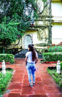 Rear view of woman standing against trees