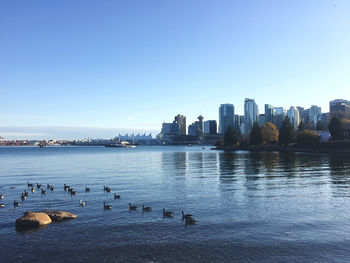 View of city buildings against clear sky