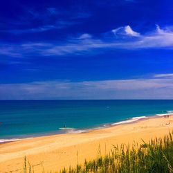 View of beach against blue sky