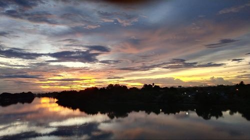 Scenic view of lake against sky during sunset