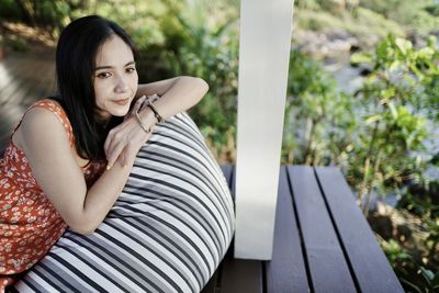 Young woman sitting on bench