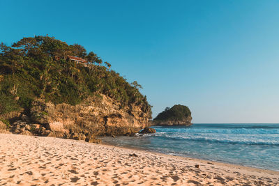 Scenic view of sea against clear blue sky