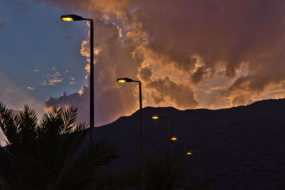 Low angle view of silhouette palm trees against sky at sunset