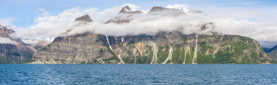 Calm lake against rocky mountains