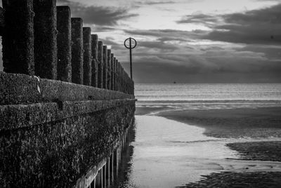 View of sea at beach against cloudy sky