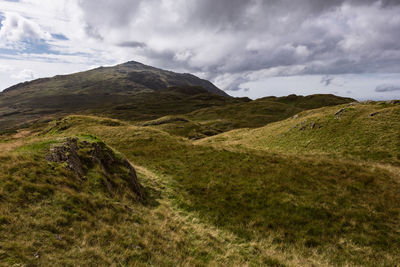 Scenic view of mountains against cloudy sky