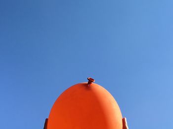 High section of built structure against clear blue sky