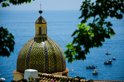 Santa maria assunta church in positano - detail of the dome against the sea.