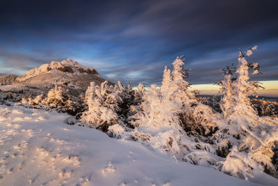 Snow covered mountains against sky during sunset