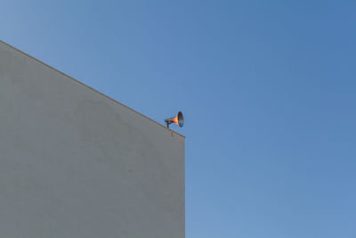 Low angle view of building against clear blue sky