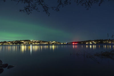 Scenic view of lake against sky at night