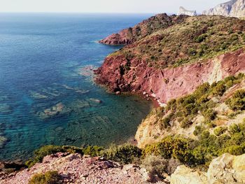 Red rocks on a crystal clear sea