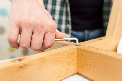 Midsection of man working in workshop