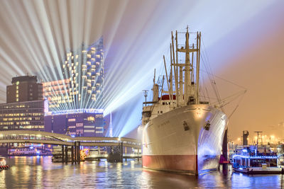 Illuminated harbor in city at night