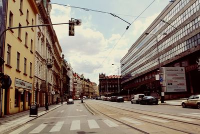 Vehicles on road along buildings