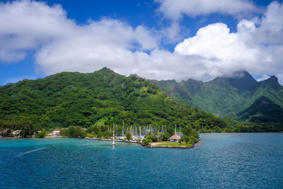 Scenic view of sea and mountains against sky