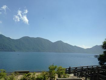 Scenic view of sea and mountains against sky