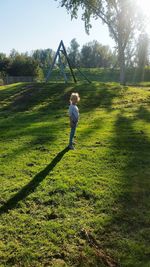 Rear view of boy on field