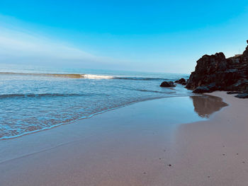 Scenic view of sea against blue sky