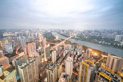 High angle view of modern buildings in city against sky