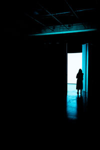 Silhouette man walking in building