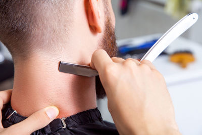 Close-up portrait of man using mobile phone