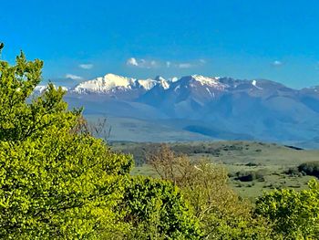 Scenic view of mountains against blue sky