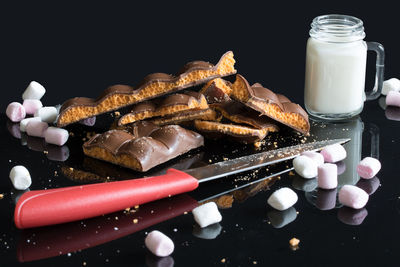 Close-up of cake against black background